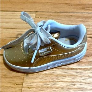 Gold puma shoes